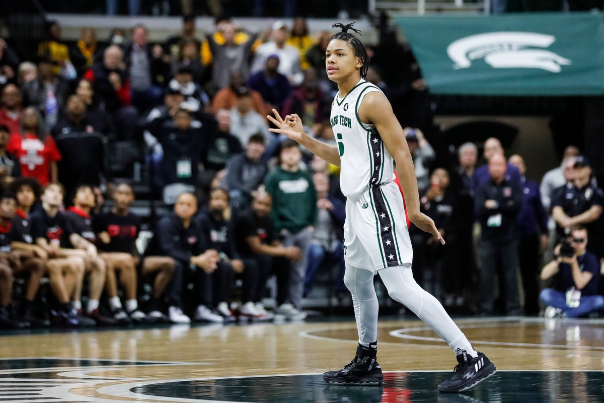 Detroit Cass Tech guard Darius Acuff celebrates a 3-point basket that tied the game at the end of the second half of Cass Tech's 62-56 overtime win in the Division 1 semifinal at Breslin Center on Friday, March 24, 2023.